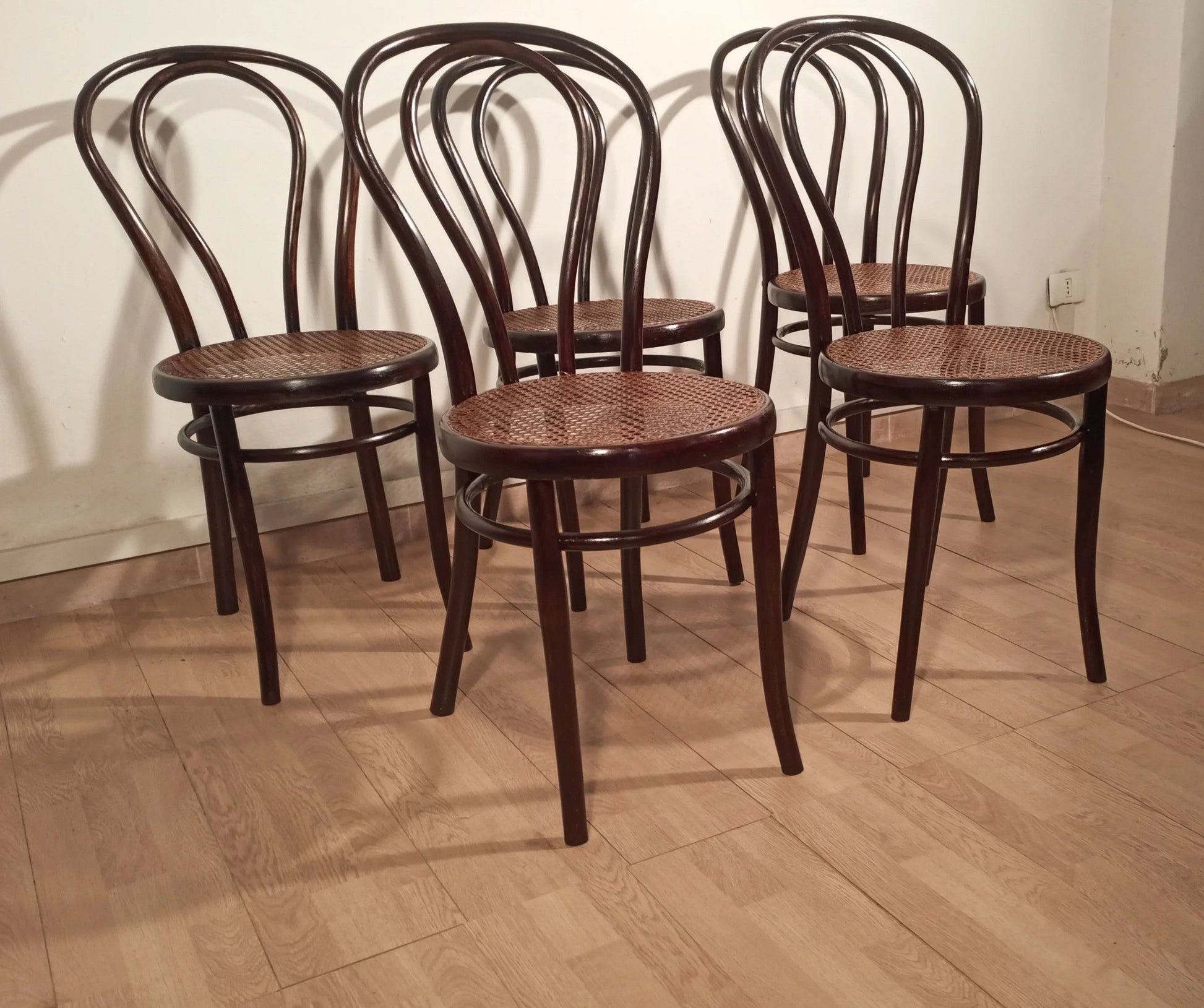 Four vintage Thonet Drava style chairs with curved backs and woven cane seats, set of 5