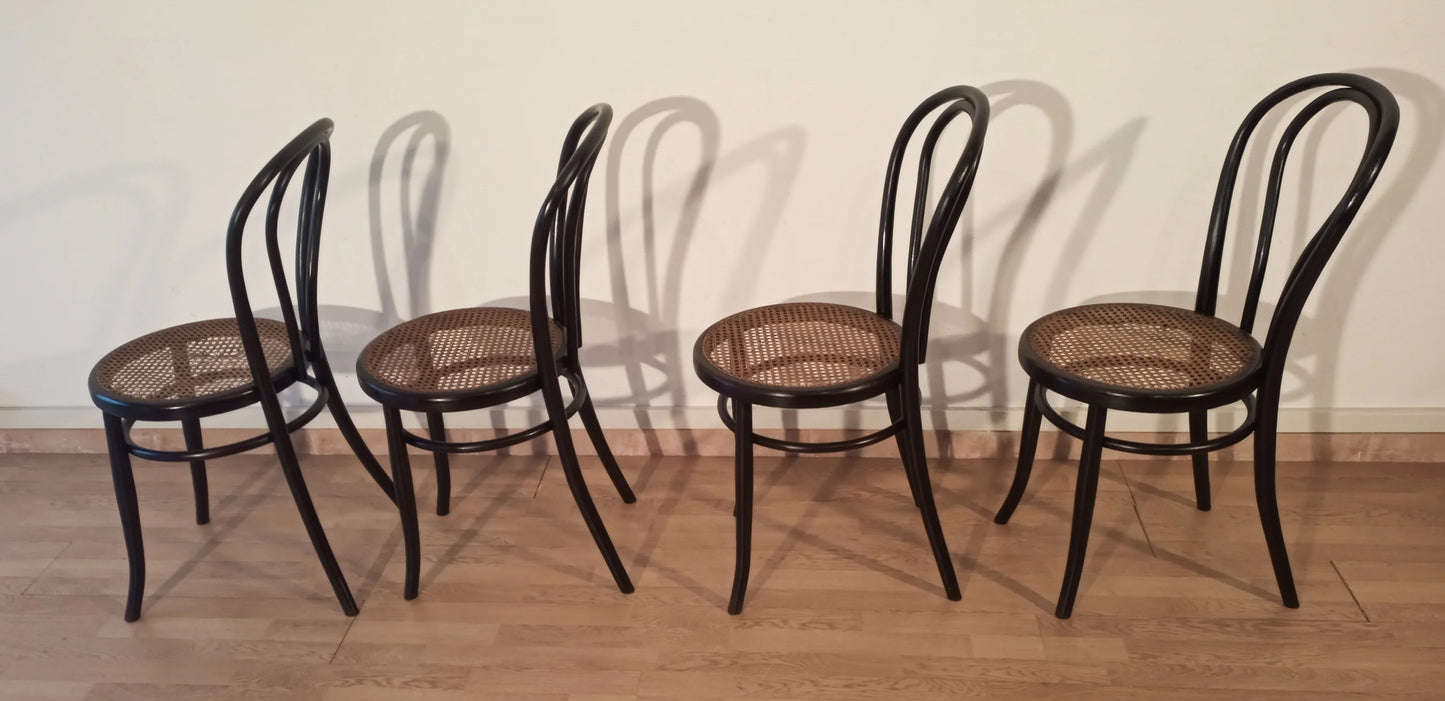 Thonet Italia set of four bent beech dining chairs with cane seats, arranged in a row