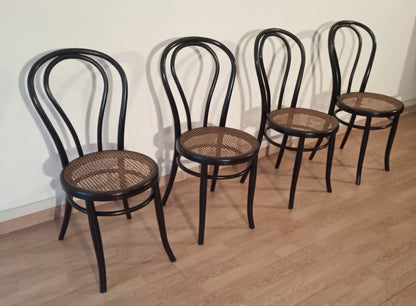 Thonet Italia set of four bent beech dining chairs with straw seats arranged in a row