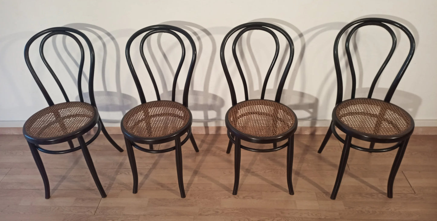 Set of 4 dining chairs in bent beech with cane seat in the Thonet Italia style arranged in a row