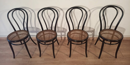 Set of 4 dining chairs in bent beech with cane seat in the Thonet Italia style arranged in a row